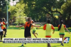Young athletes playing soccer outdoors during a youth sports festival.