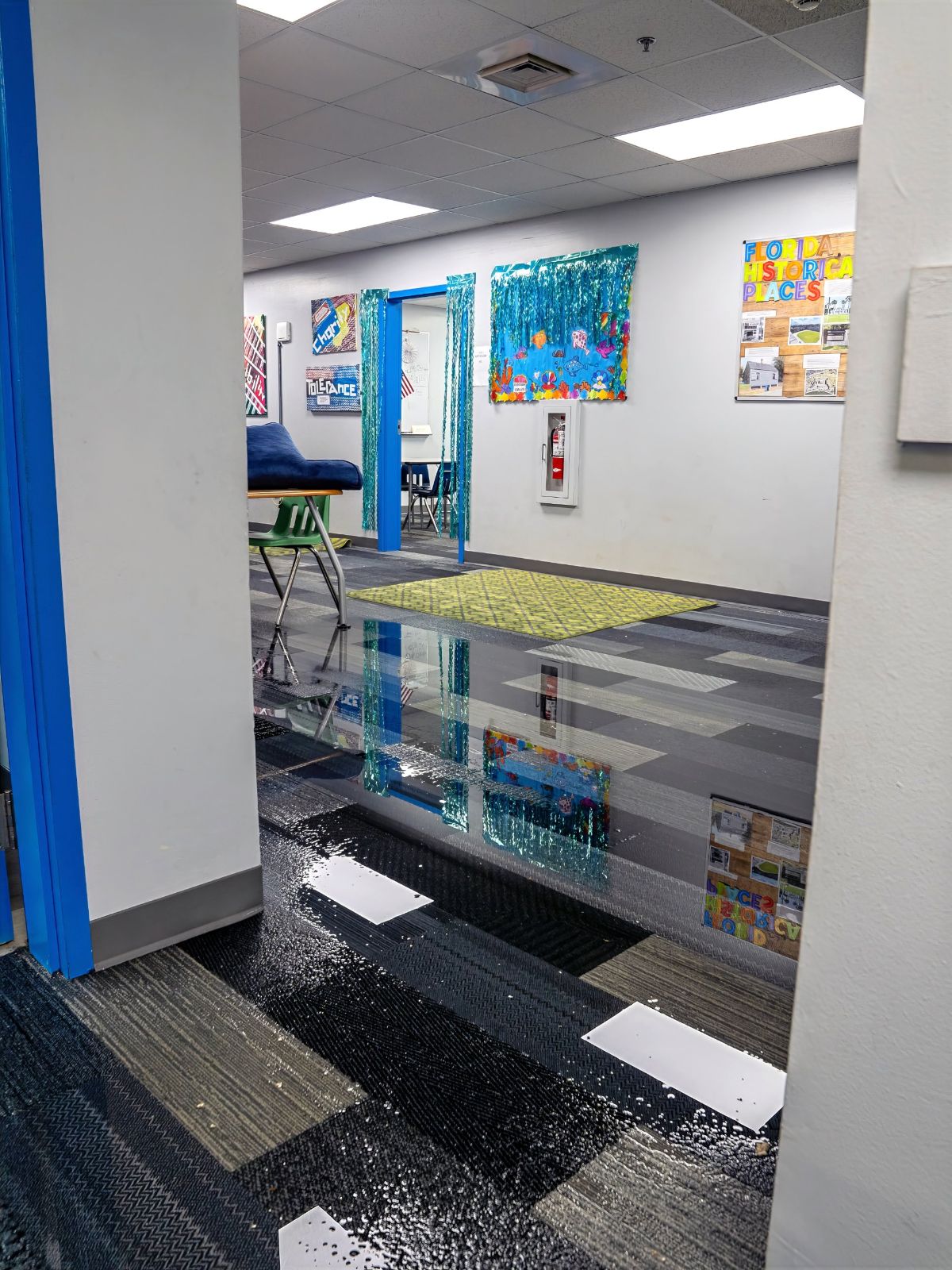 Standing water on the floor of a hallway at The Bridge