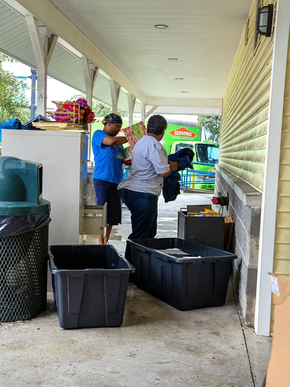 Staff moving supplies out of The Bridge after the flood